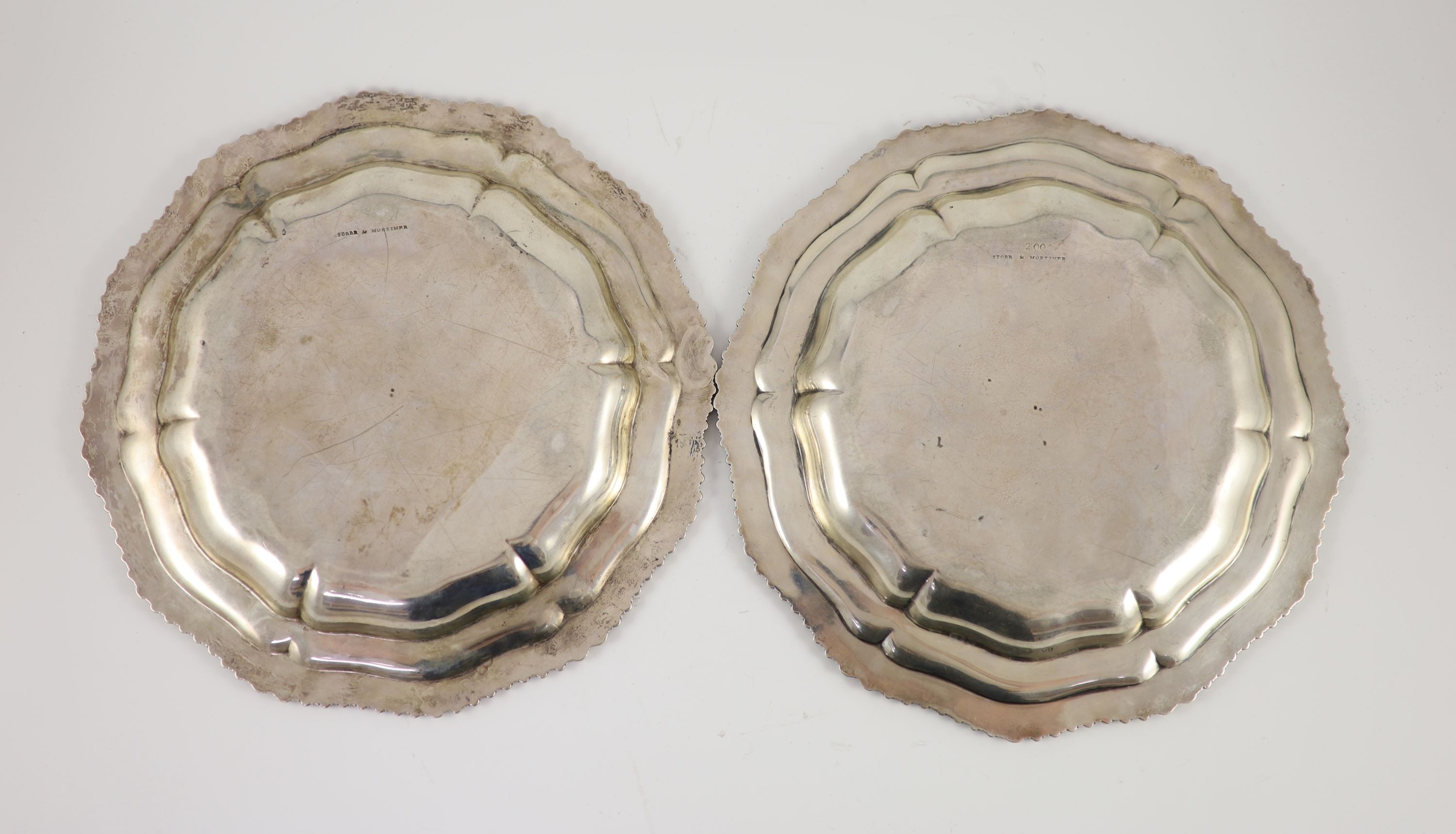 A pair of late George IV silver shaped circular dinner plates by Paul Storr